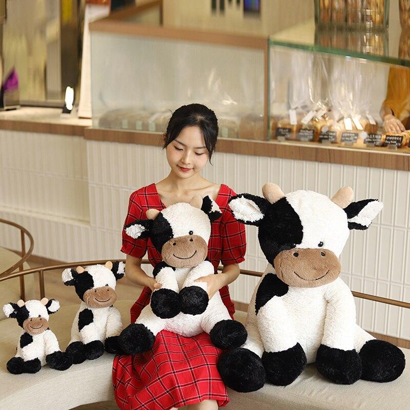 Soft, huggable spotty cow plush toy in white with black spots. Made with premium PP cotton, hypoallergenic & perfect for cuddling.