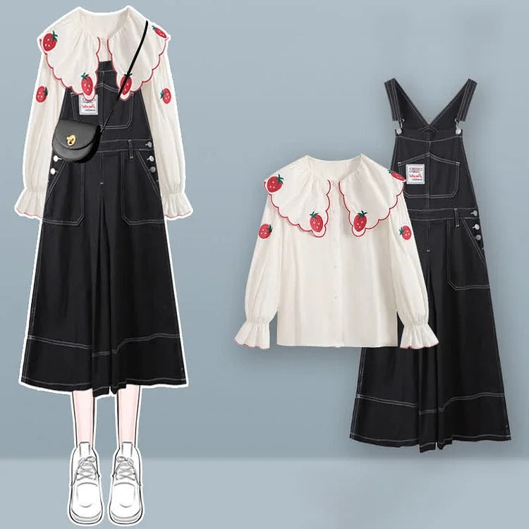 Charming white shirt with strawberry embroidery & black denim overall dress; long sleeves, preppy style.