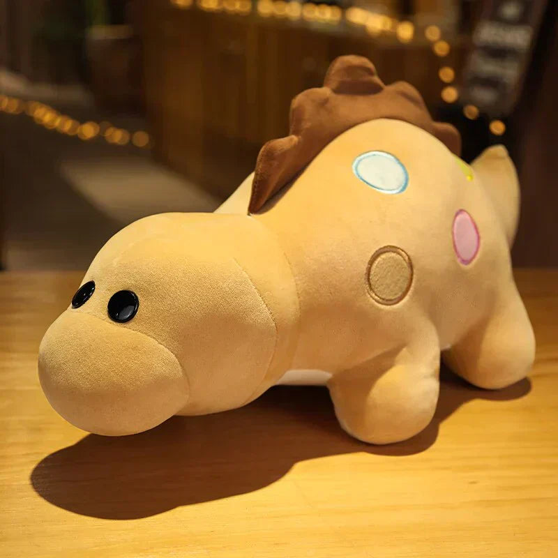 Tan chibi dinosaur plush toy with colorful polka dots, soft PP cotton, and three available sizes.