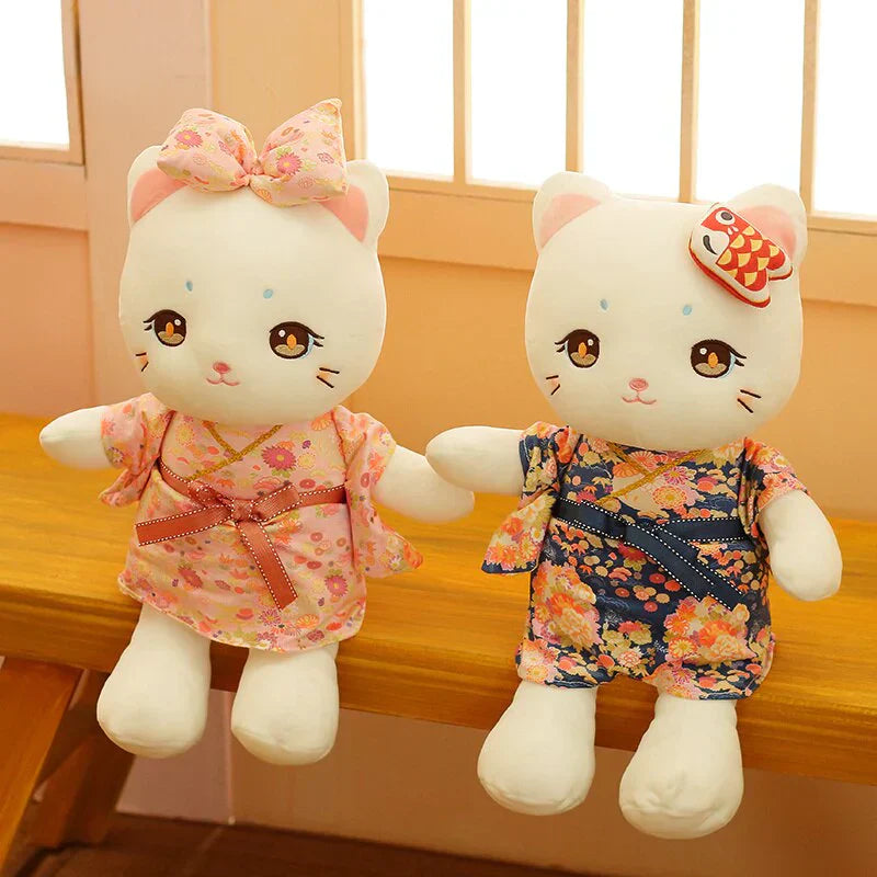 Adorable white cat plush toys in pink and blue floral kimonos. Soft PP cotton filling, perfect for cuddling and gifting.
