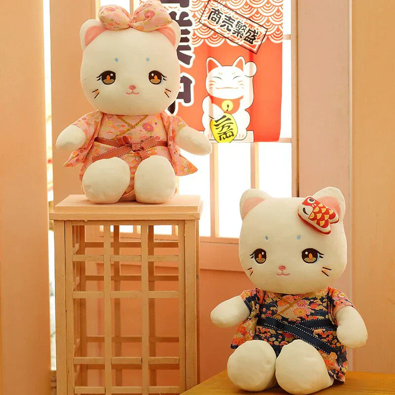 Adorable white cat plush toy wearing a pink or blue floral kimono. Soft PP cotton filling, perfect for cuddling and sleep. Two sizes available.