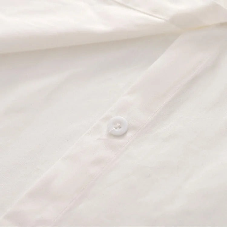 White polyester shirt with strawberry embroidery, part of a preppy denim overall dress set. Long sleeves, long dress.